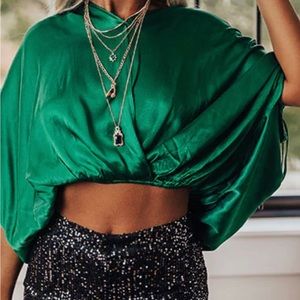 Satin top with tie sleeves and neck as well as a stretch elastic cropped waist.